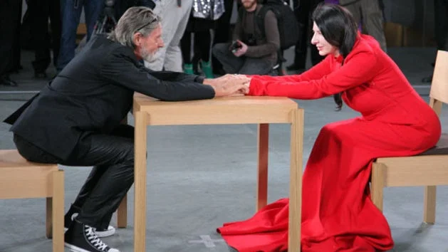 Marina Abramovic sentada frente a un visitante en una performance en vivo Marina Abramović sentada frente a un visitante en una performance en vivo